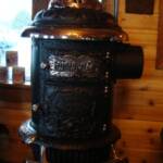 D-14 East coast Round Oak stove. Original three feathered Indian finial with a reproduction peace-pipe.
$2450.00